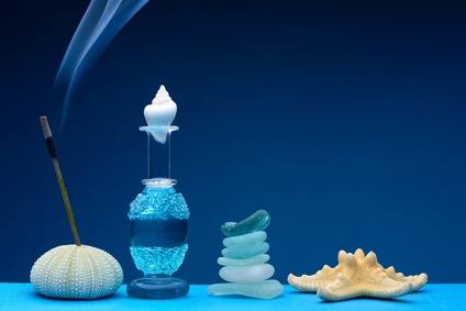 Small bottles of perfume dacorated with smoke from aromatic sticks
